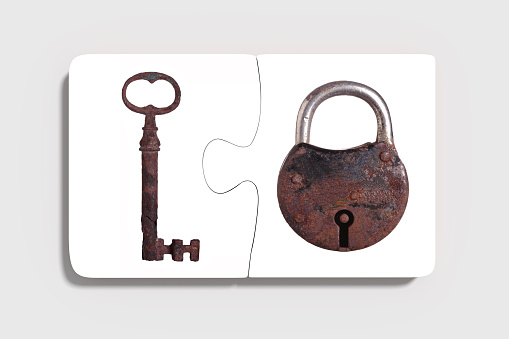 3d rendering of Two three-dimensional pieces of puzzle with rusty padlock and key on grey background. From above. Isolated.