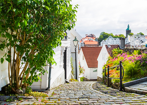 Street with white wooden houses in old centre of Stavanger. Norway.