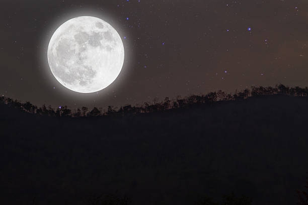 istock Full moon with stars over mountain on darkness sky. 523243704