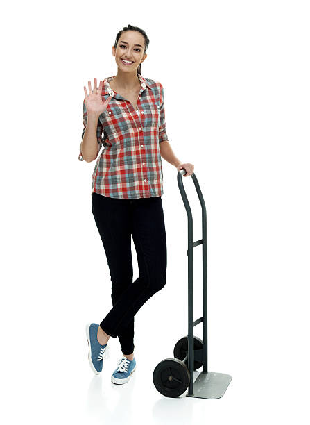 istock Smiling female holding hand truck 523243706