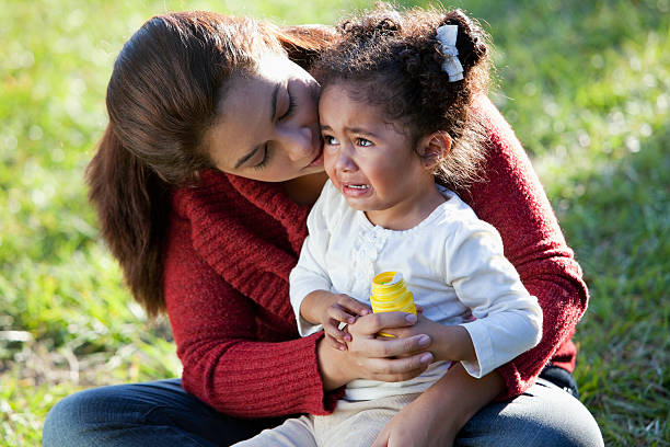 Hispanic mother comforting crying daughter