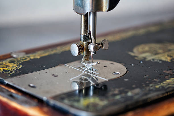 istock needle and thread closeup in an old vintage sewing machine 523245240