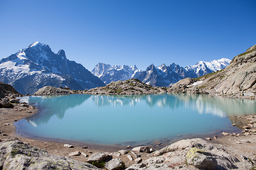 The majestic snow capped mont blanc massif reflected in the crystal clear waters of Lac Blanc in the French Alps near Chamonix