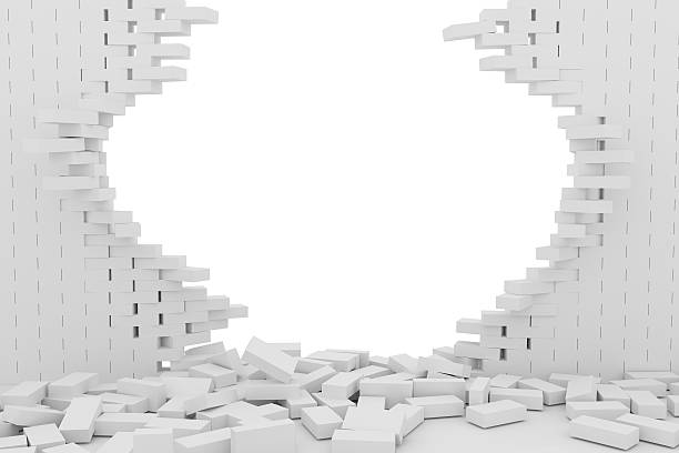 istock Destruction of a white brick wall on white background 523245320