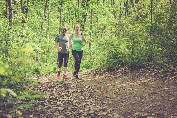 istock Young woman and elderly man running outdoors on fresh air 523245866