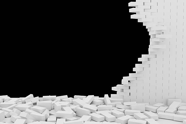 istock Destruction of a white brick wall on black background 523247068