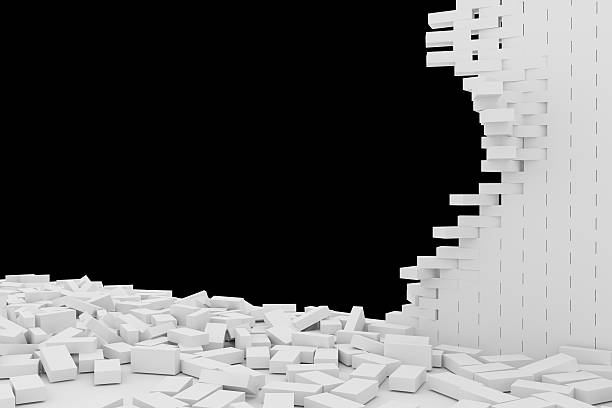 istock Destruction of a white brick wall on black background 523247318