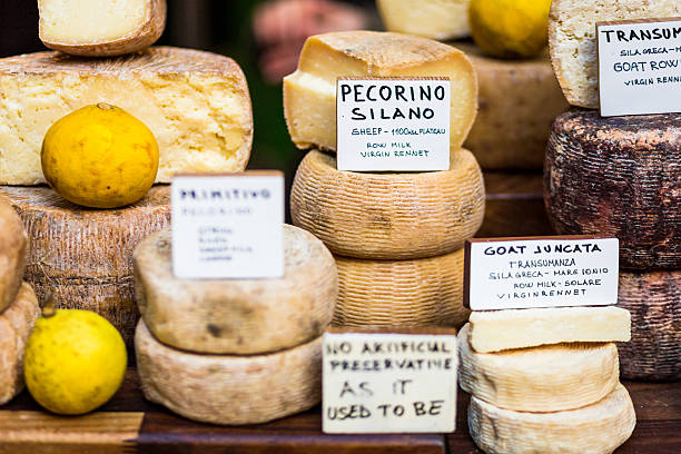 Selection of Cheeses on Sale at Borough Market, London An appetising selection of continental cheeses on sale at Borough Market in London, UK. Horizontal colour image. borough market stock pictures, royalty-free photos & images