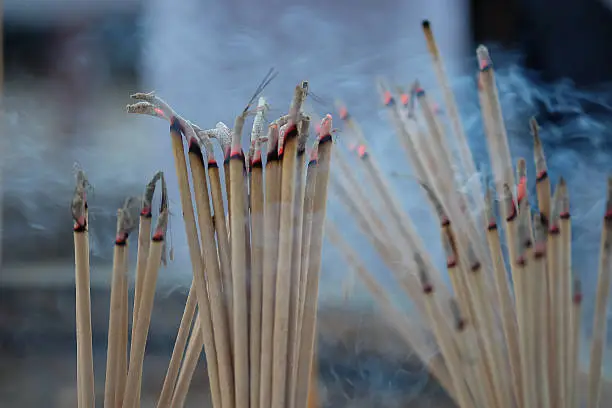 Photo of Blur burning incense and candle  for backgroud,abstract