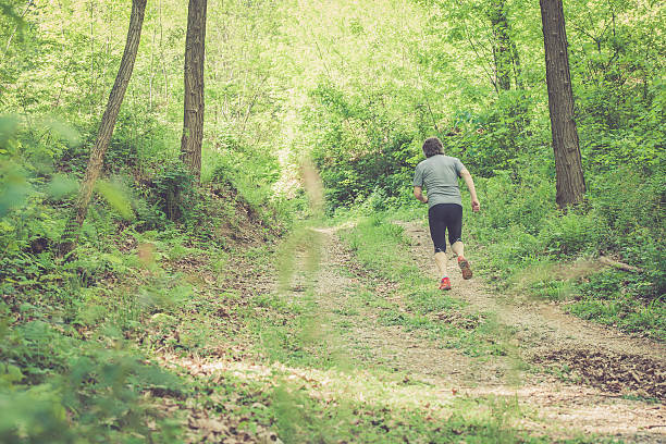 istock Caucasian elderly man running up in forest - rear view 523253492