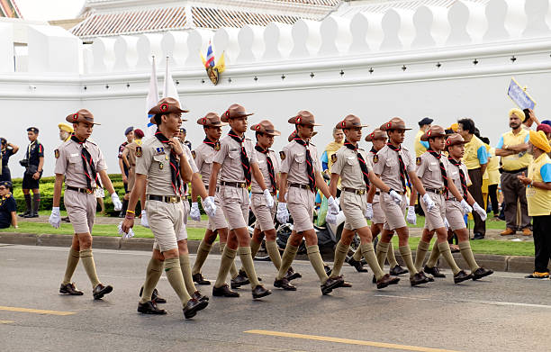 Bangkok, Thailand - December 5, 2015: Unidentified Boy scouts participates in the parade on celebrating of the King Rama 9 birthday at the walls of the Grand Palace, Bangkok, Thailand.