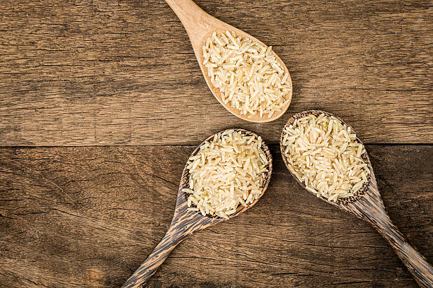istock Brown rice on wooden spoon 523255494
