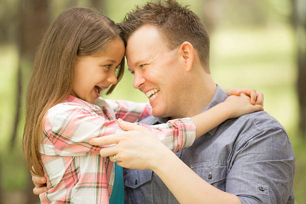 istock Father, daughter hugging outdoors. Parent, child. Love, affection. 523255702