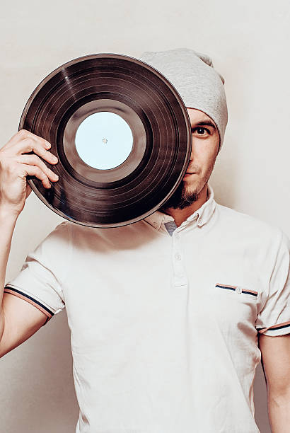 istock stylish man with vinyl record 523255760