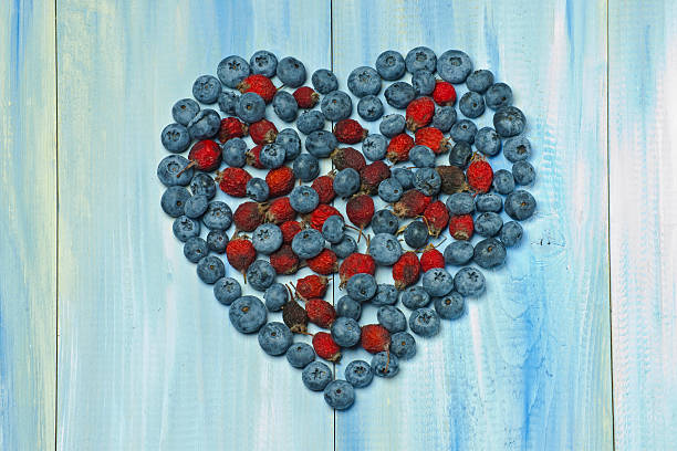 istock rosehip berries and blueberries in a heart shape 523257892
