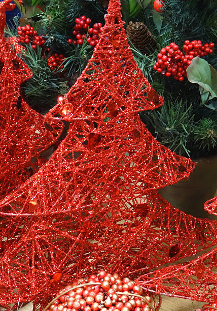 istock Wicker Christmas trees / decorations, painted with sparkling red glitter paint 523259071