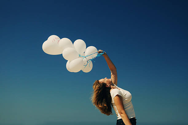 istock Beautiful woman holding balloons 523259276