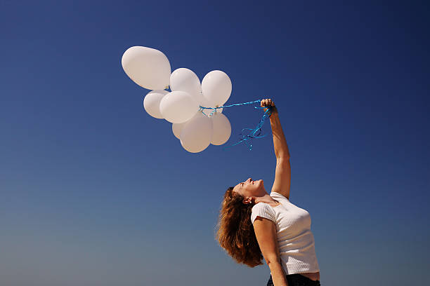 istock Beautiful woman holding balloons 523259318