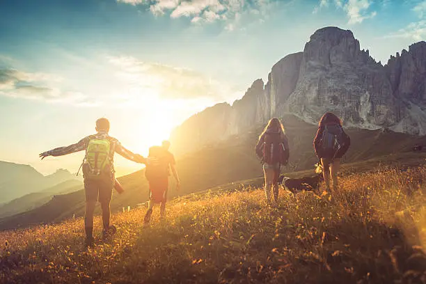 A group of teenage friends, together with a dog (border collie), adventures on the mountain, on the Italian Dolomites.