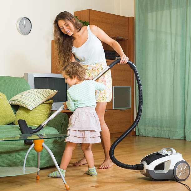 istock Family with vacuum cleaner 523259815