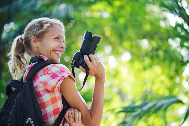 istock Young woman taking photos with camera 523259920