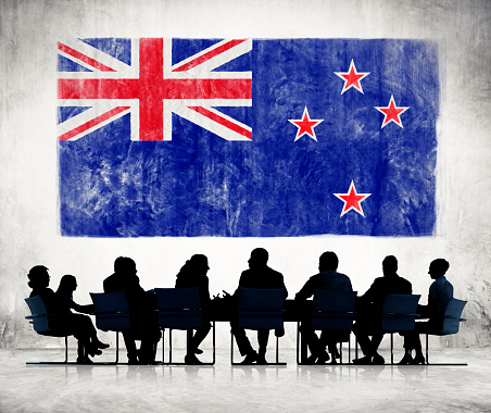 Silhouettes of Business People and a Flag of New Zealand