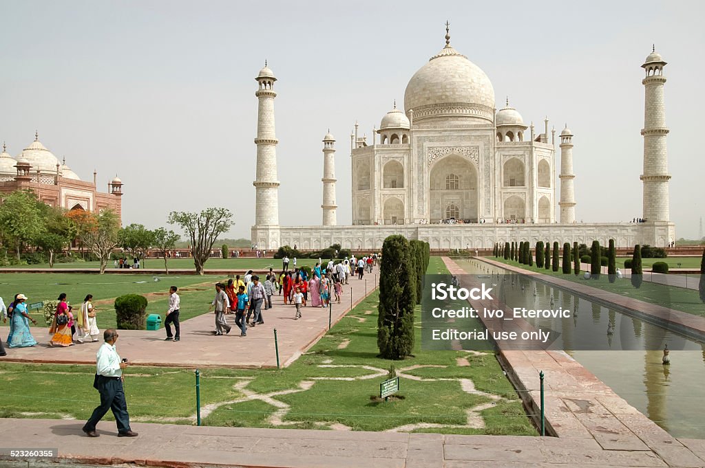 Taj Mahal in Agra, India Agra, India - April 22, 2007: Unidentified people in front of Taj Mahal in Agra, India. It was built by Mughal emperor Shah Jahan in memory of his third wife, Mumtaz Mahal and was opened at 1648. Agra Stock Photo