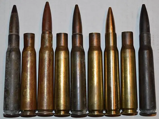 Photo of assortment of 50 caliber bullets and shell casings