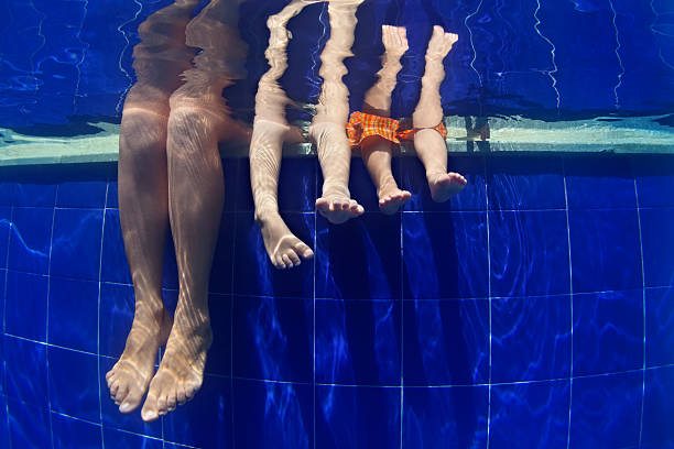 "funny underwater photo mother with kids legs in swimming pool - baby swim under water bildbanksfoton och bilder