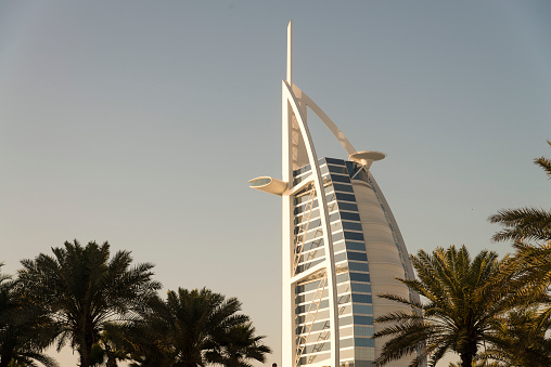 Dubai, United Arab Emirates - March 26, 2016: The top of the Burj Al Arab seen from the Madinat Jumeirah district in Dubai during the day. Burj Al Arab is the only seven star hotel in the world.