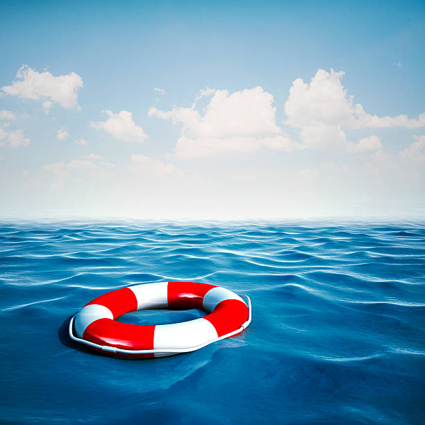 istock 3d life buoy and ocean with blue sky background 523261347