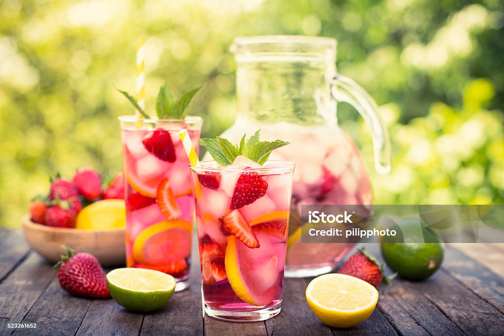 Pink lemonade with lemon, lime and strawberries Pink lemonade with lemon, lime and strawberries  Summer Stock Photo