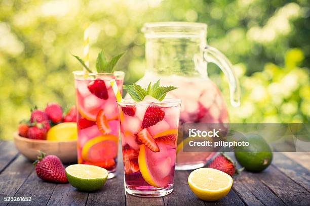 Pink Lemonade With Lemon Lime And Strawberries Stock Photo - Download Image Now - Summer, Drink, Fruit