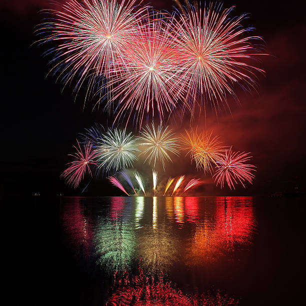 Colorful fireworks with reflection on lake. stock photo