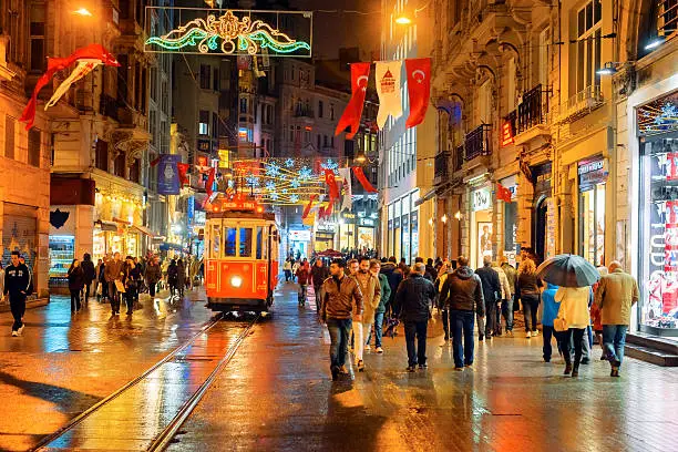 Illuminated Tramway on a rainy Istiklal Avenue (Independence Avenue), Lots of national flags for the Republic Day. iStockalypse. Nikon D3x