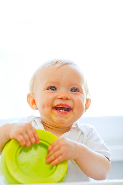 istock Eat smeared smiling baby  playing with plate 523263745