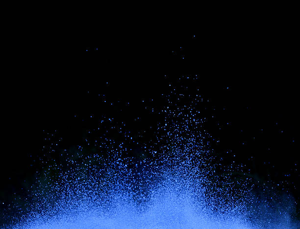 istock Explosion of blue powder on black background 523265072
