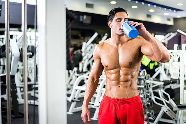 istock Man drinking protein shake in the gym 523265143