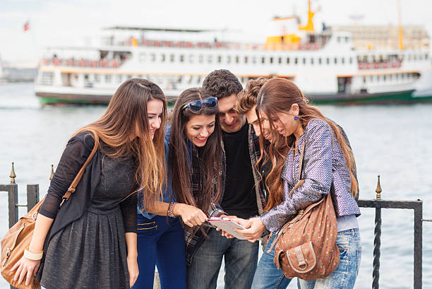 istock Turkish young friends watching funny video on tablet computer 523265519