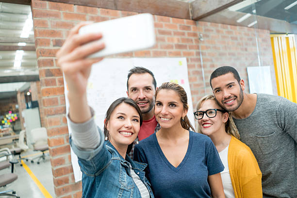istock Group of friends taking a selfie at the office 523265706