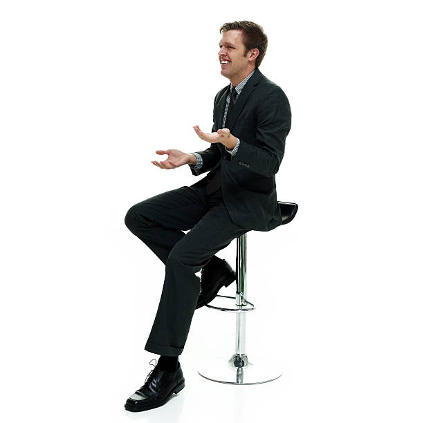 istock Smiling businessman sitting and gesturing 523266248