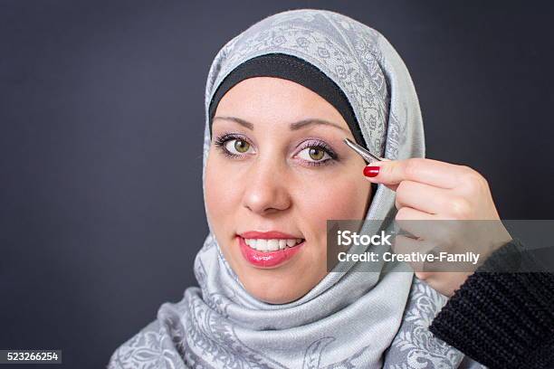 Muslim Woman Plucking Eyebrows Stock Photo - Download Image Now - Islam, Mirror - Object, 20-29 Years