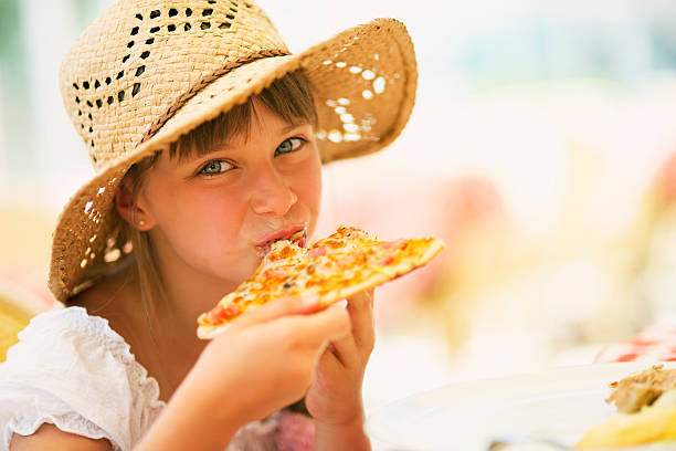 istock Little girl eating pizza 523271705