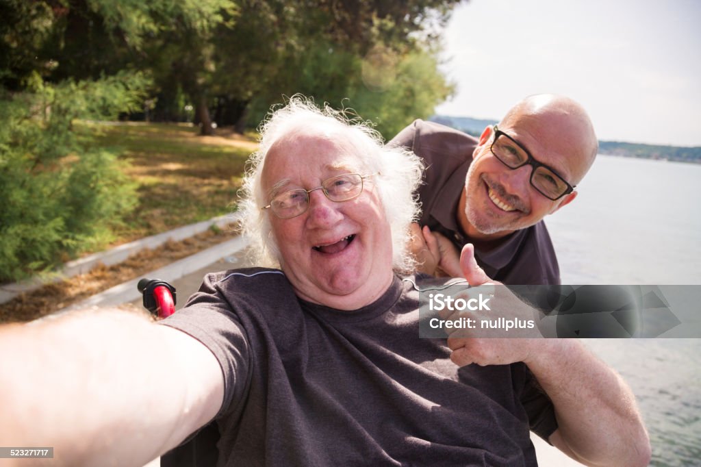 old man in wheelchair taking a selfie with his phone Disability Stock Photo