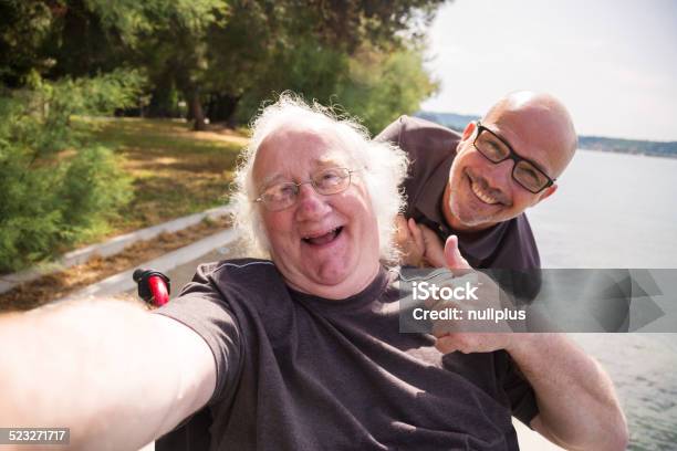 Old Man In Wheelchair Taking A Selfie With His Phone Stock Photo - Download Image Now