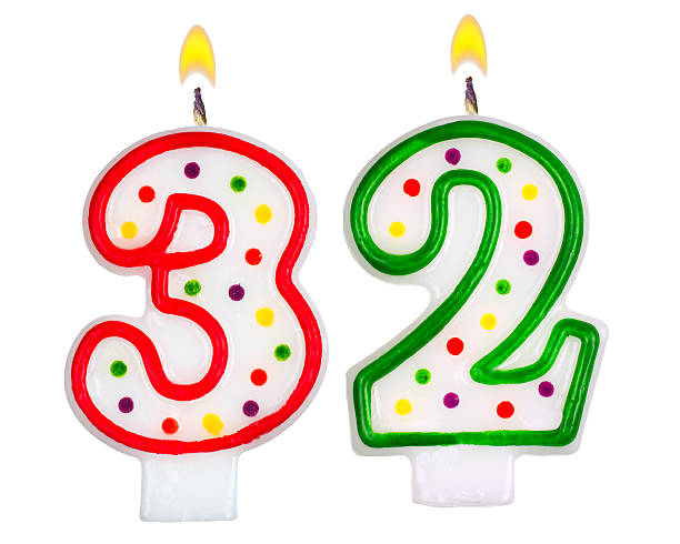 istock Birthday candles number thirty two isolated on white background 523272161