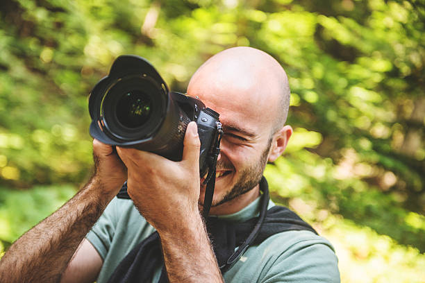 istock photographer smiling on the woods 523274067