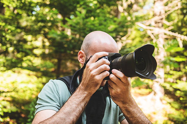 istock photographer smiling on the woods 523274069