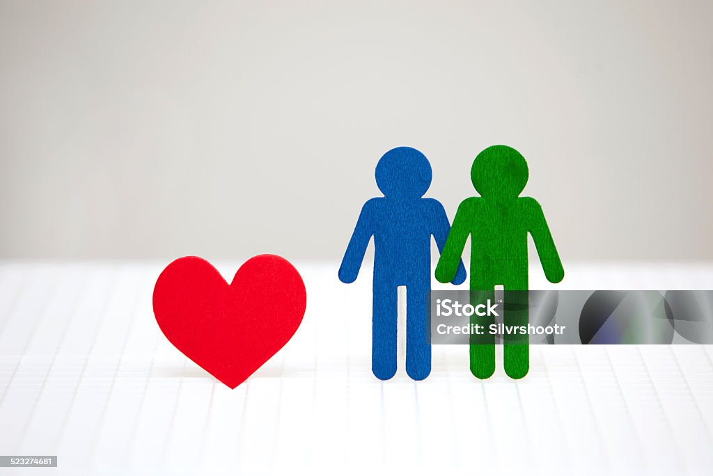 Anthropomorphic couple with a heart. Two males are side by side, accompanied by a large red heart. Not an illustration. Adult Stock Photo