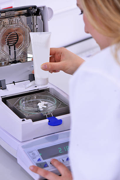 istock Worker Measuring Cream at Laboratory Weighing Balances 523276365